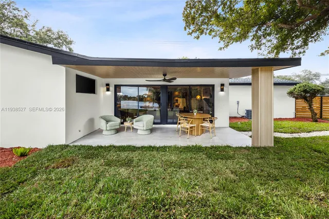 a view of a yard with a house and a large tree