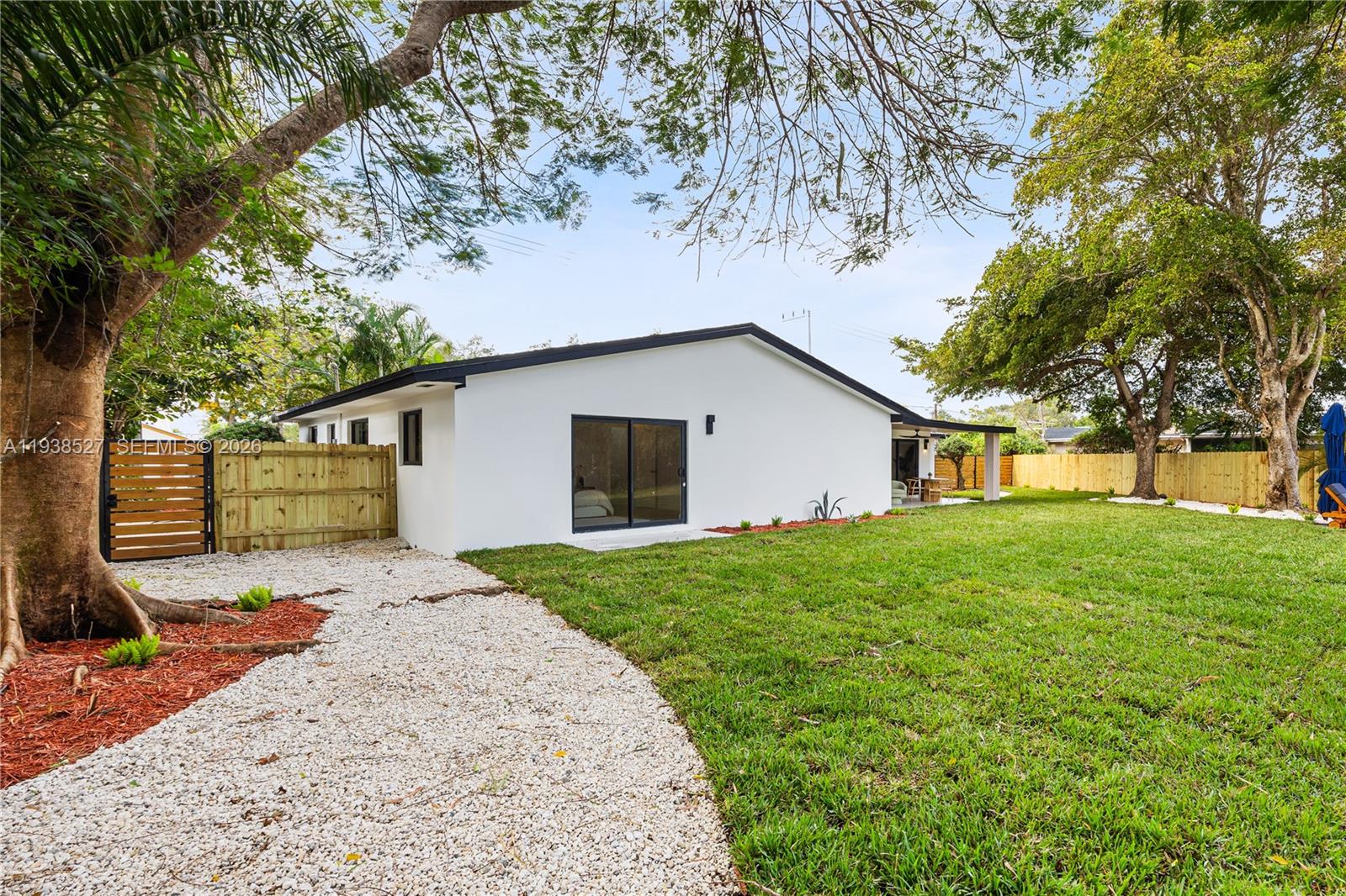 10415 Southwest 87th Avenue Miami, FL 33156 - Photo 36 of 53 a view of a yard with a house and a large tree