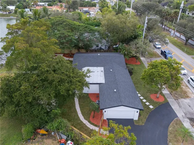 an aerial view of residential houses with outdoor space and lake view