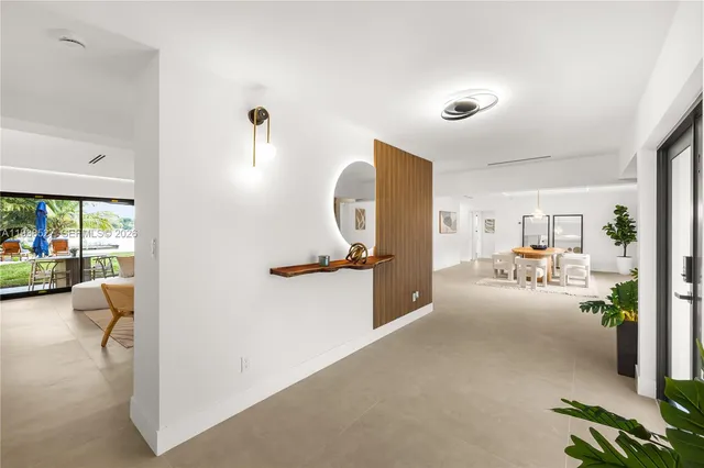 a view of a livingroom with furniture and a floor to ceiling window