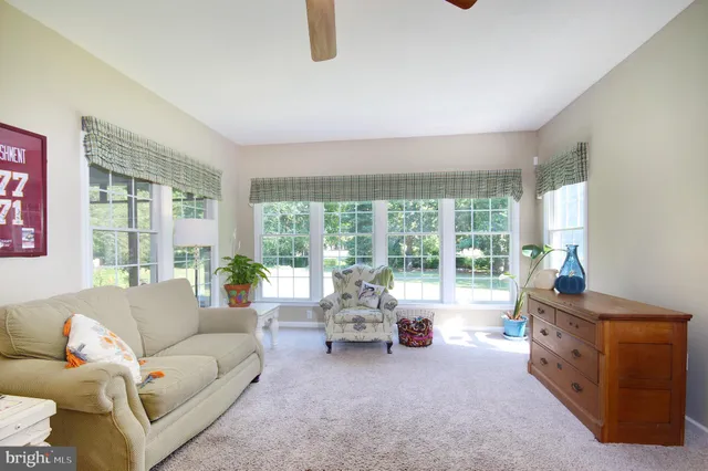 a living room with furniture and large windows