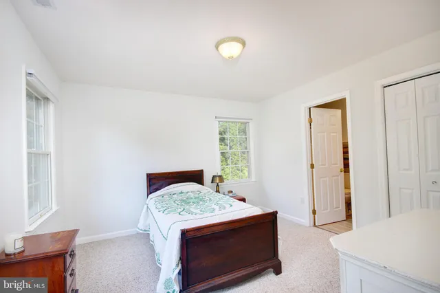 a view of bedroom with furniture and wooden floor