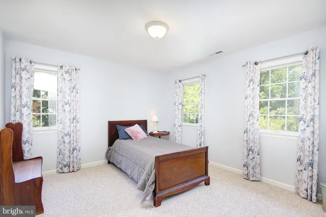 a bedroom with furniture and a window