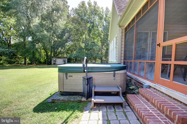 a view of a chairs and table on the patio in front of a house