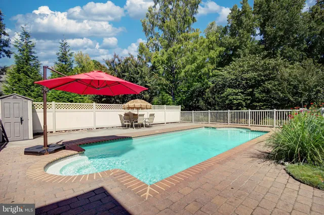 a view of a backyard with a patio and fire pit