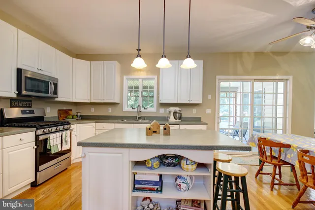 a kitchen with a table chairs stove and cabinets