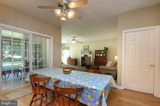 a dining room with furniture and wooden floor