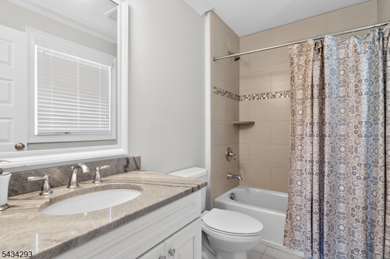 921 Harding Street Westfield, NJ 07090 - Photo 35 of 50 a bathroom with a granite countertop sink toilet and shower