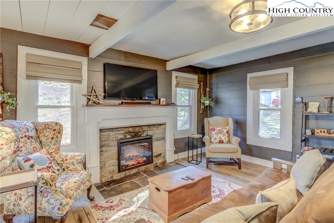 148 Fox Hill Road Vilas, NC 28692 - Photo 11 of 25 a living room with furniture a flat screen tv and a fireplace