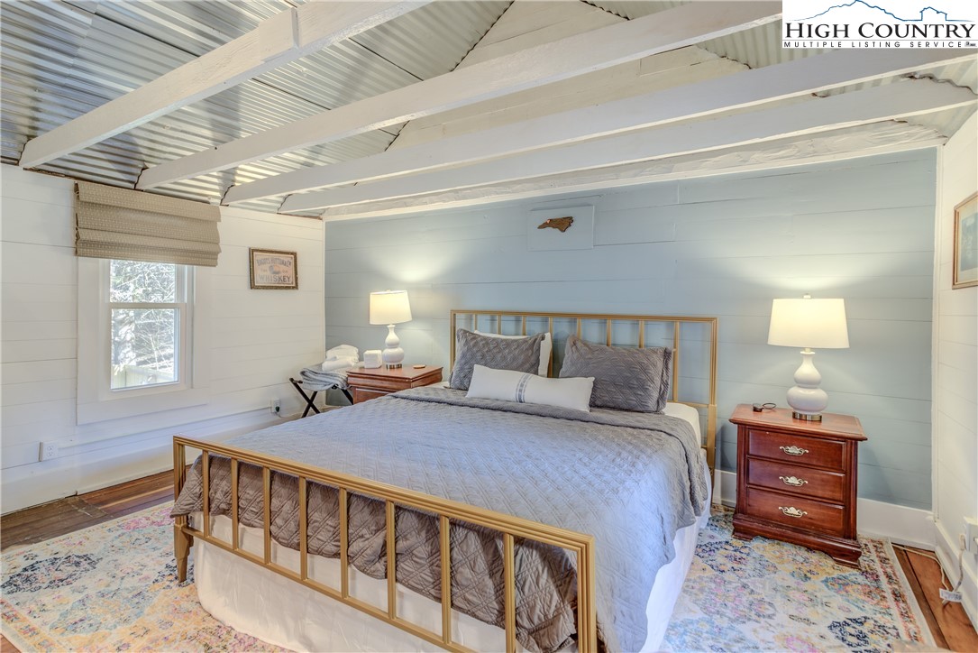148 Fox Hill Road Vilas, NC 28692 - Photo 18 of 25 a bedroom with a bed and wooden floor