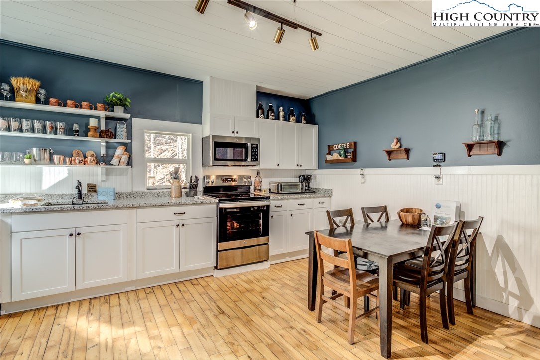 148 Fox Hill Road Vilas, NC 28692 - Photo 6 of 25 a kitchen with granite countertop stainless steel appliances a dining table and chairs in it