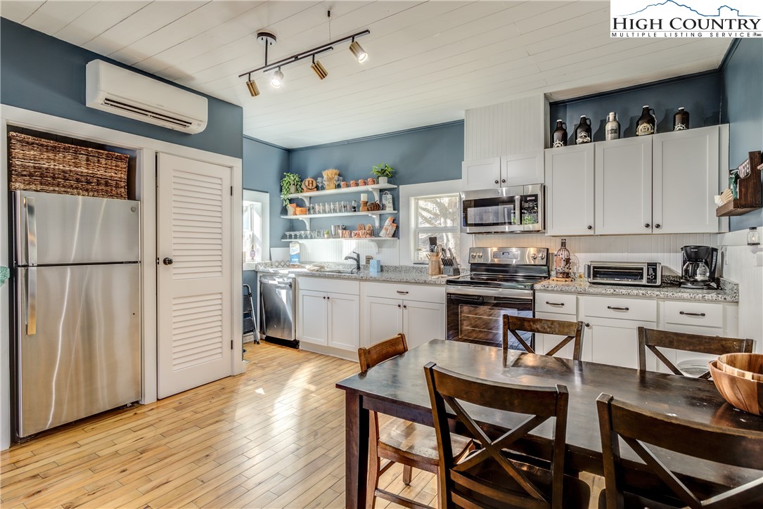 148 Fox Hill Road Vilas, NC 28692 - Photo 8 of 25 a kitchen with a sink cabinets stainless steel appliances and dining table