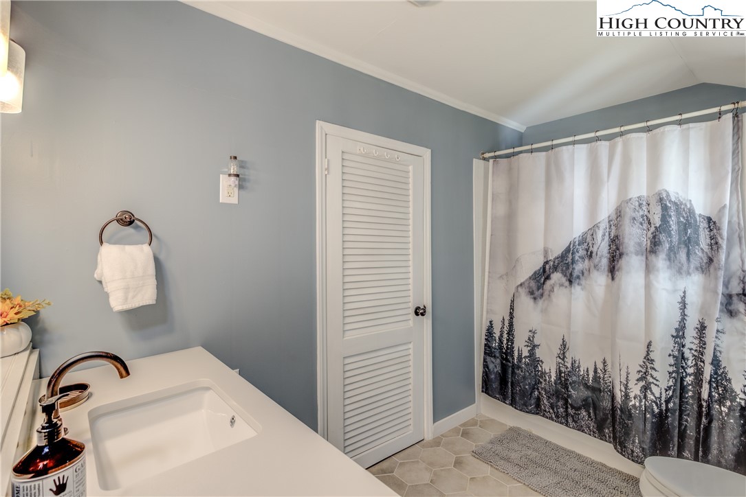 148 Fox Hill Road Vilas, NC 28692 - Photo 9 of 25 a bathroom with a sink and mirror