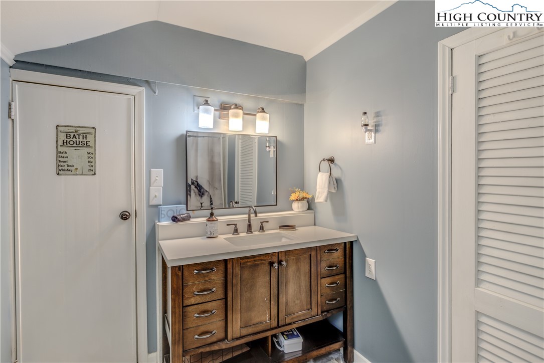 148 Fox Hill Road Vilas, NC 28692 - Photo 10 of 25 a bathroom with a sink vanity and mirror
