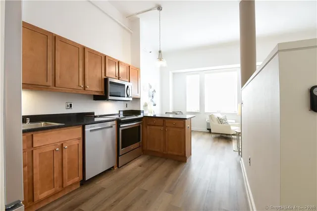 a kitchen with sink a microwave a stove and refrigerator