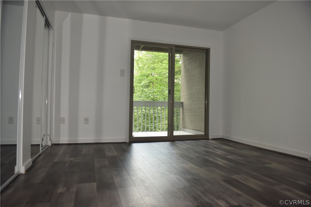 10320 Iron Mill Road, Unit 10320 Richmond, VA 23235 - Photo 3 of 14 a view of an empty room with wooden floor and a window