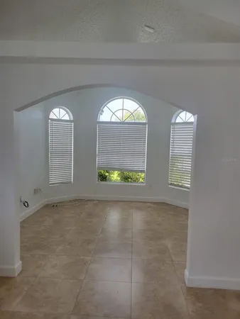 a view of an empty room and a window