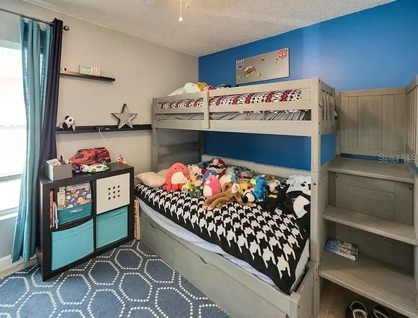 a kitchen area with stainless steel appliances lots of fruit and a table