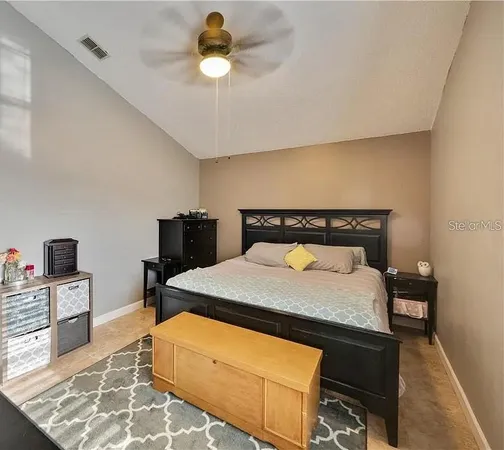 a bedroom with a bed and a television