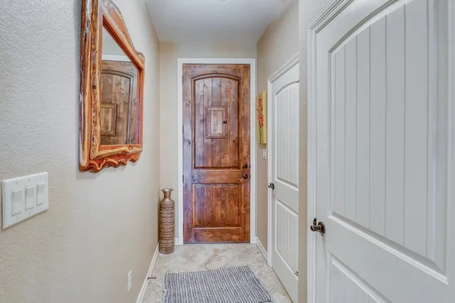 a view of a hallway view with wooden floor and closet