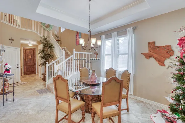 a dining room with furniture potted plants and wooden floor