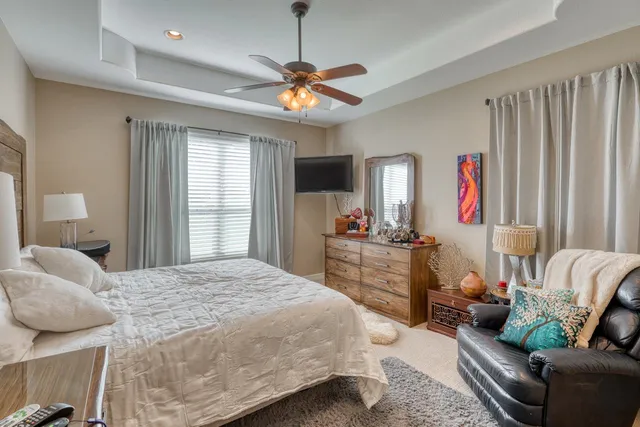 a bedroom with a bed couch and a window