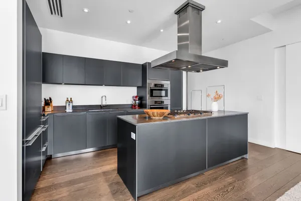a kitchen with stainless steel appliances granite countertop a stove and a sink