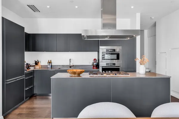 a kitchen with stainless steel appliances a sink and a refrigerator