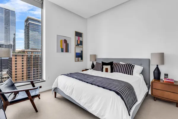 a bedroom with a bed chair and window