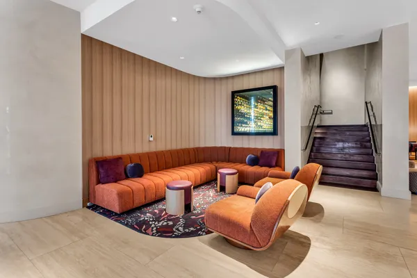 a living room with fireplace furniture and a large window