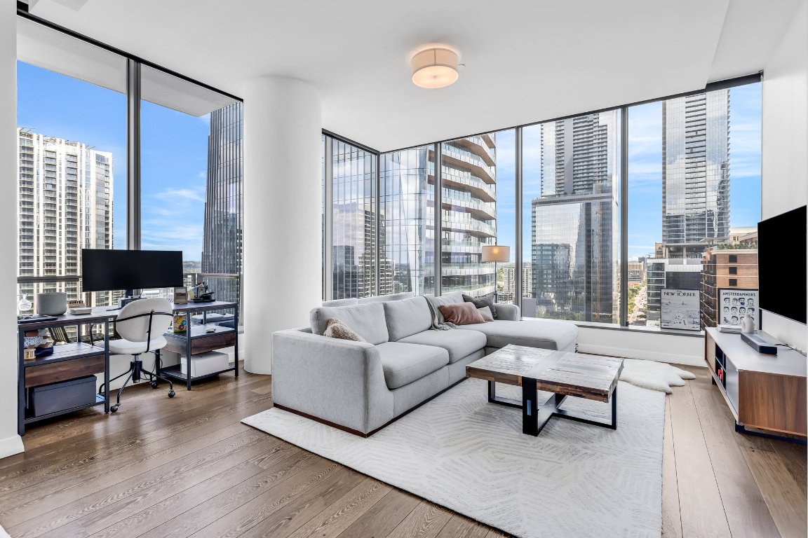 210 Lavaca Street, Unit 2308 Austin, TX 78701 - Photo 3 of 37 Living room with floor to ceiling windows and hardwood floors