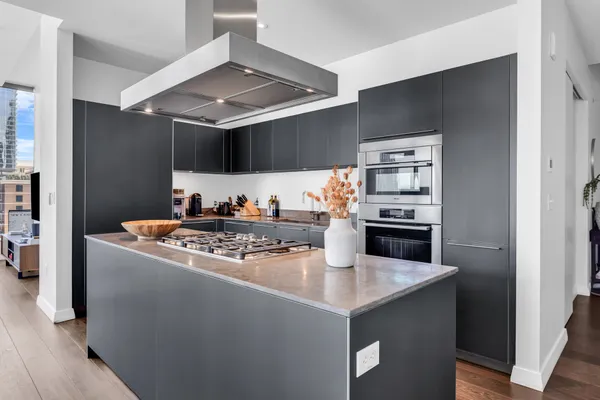 a kitchen with granite countertop a sink and stainless steel appliances