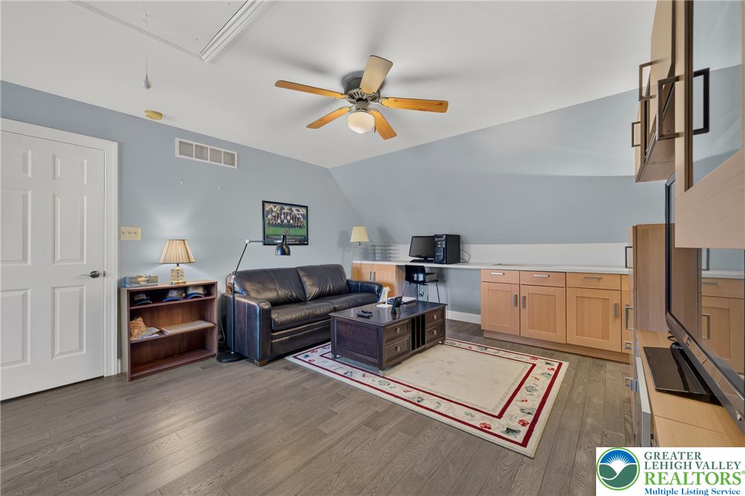 1702 Red Bud Road Quakertown, PA 18951 - Photo 50 of 68 A versatile living space with a sloped ceiling and built-in cabinetry, offering both relaxation and a dedicated workspace.