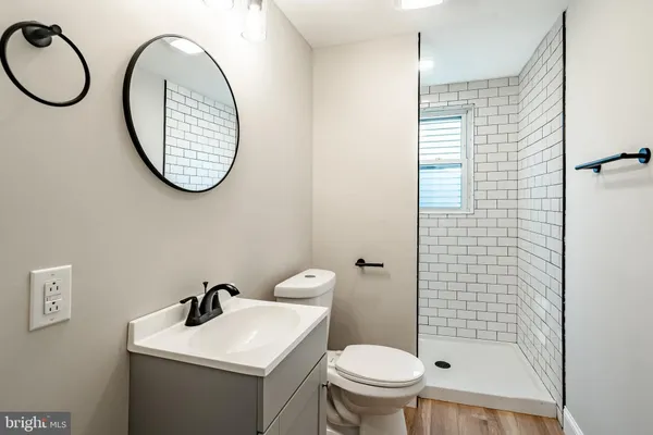a bathroom with a toilet a sink and a mirror