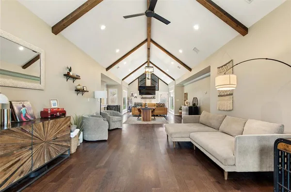 a living room with furniture and wooden floor