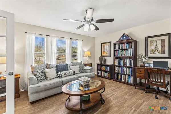 a living room with furniture and a wooden floor