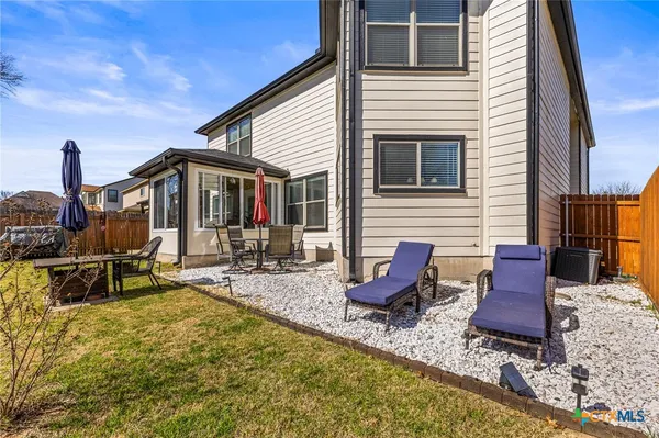 a backyard of a house with outdoor seating