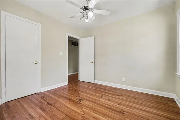 a view of an empty room with wooden floor