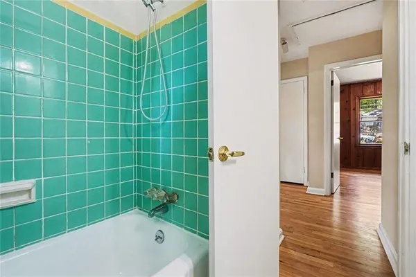 a bathroom with a bathtub and a shower