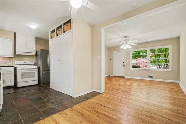 a view of a kitchen with wooden floor and electronic appliances
