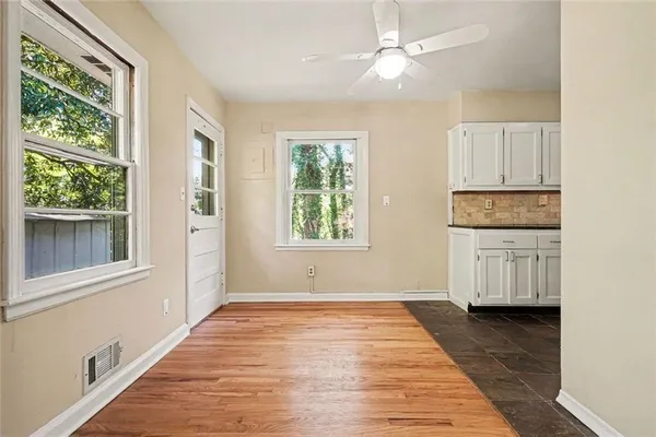 a view of a kitchen with dishwasher and wooden floor