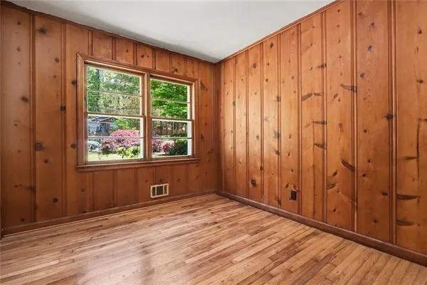 a view of wooden floor and windows in a room