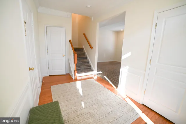 a view of entryway and hall with wooden floor