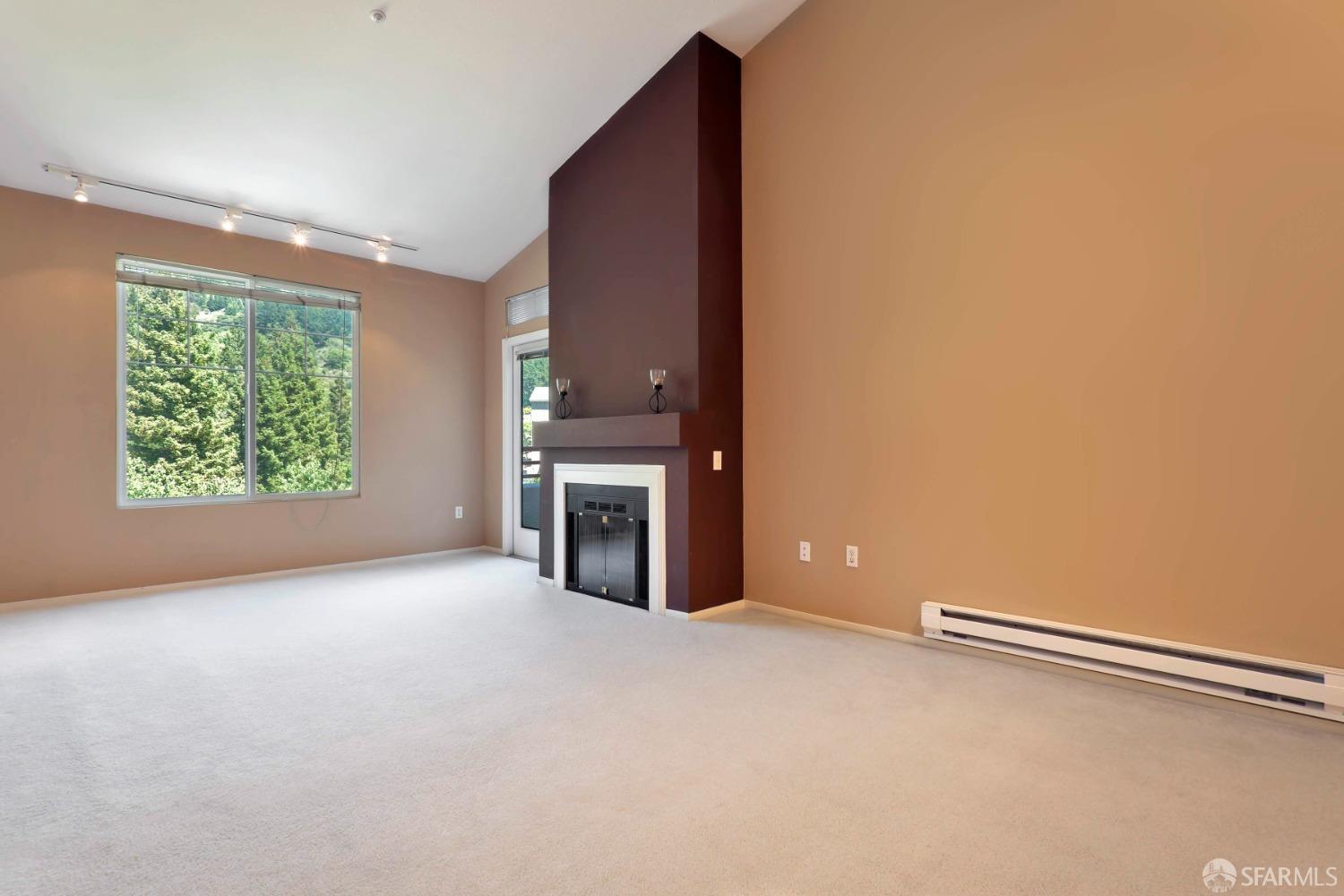 320 Caldecott Lane, Unit 331 Oakland, CA 94618 - Photo 2 of 14 a view of empty room with a fireplace and window