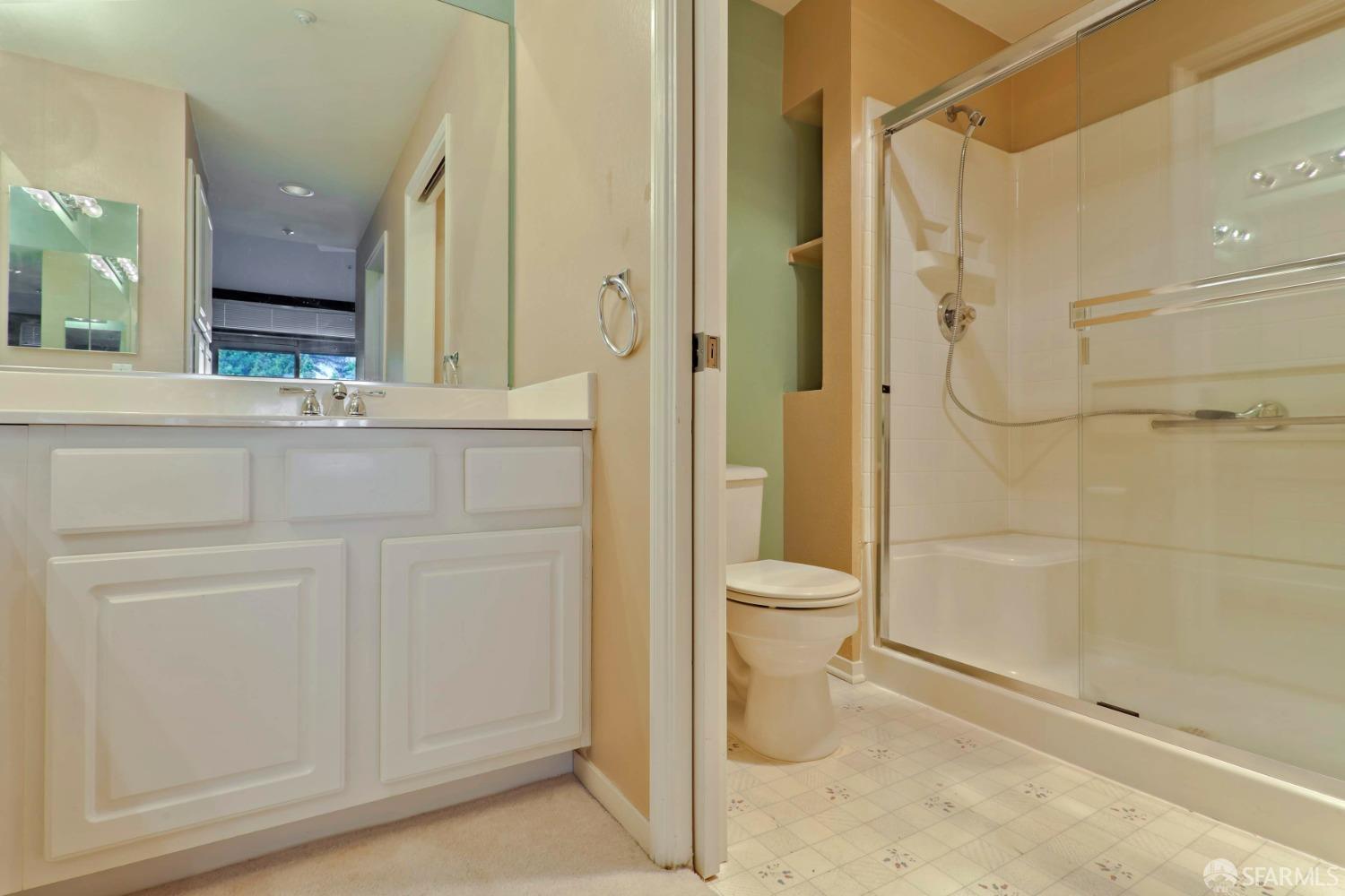 320 Caldecott Lane, Unit 331 Oakland, CA 94618 - Photo 6 of 14 a bathroom with a granite countertop sink a toilet and shower