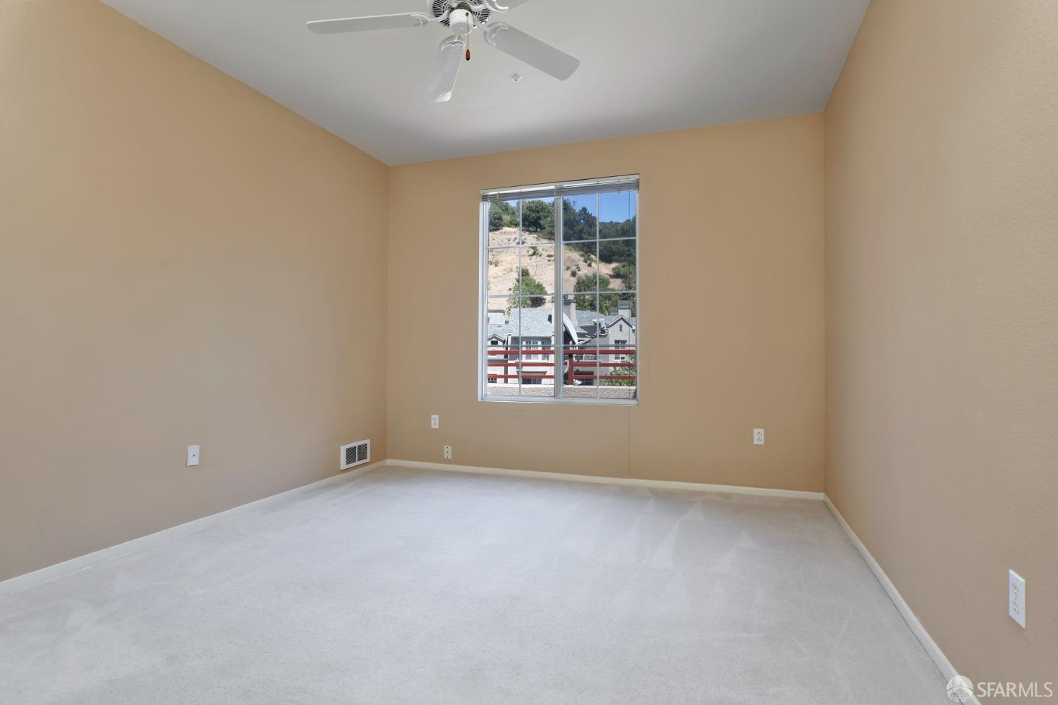 320 Caldecott Lane, Unit 331 Oakland, CA 94618 - Photo 7 of 14 an empty room with a window and a ceiling fan