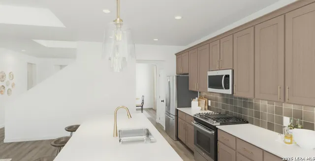 a kitchen with a sink stove and refrigerator