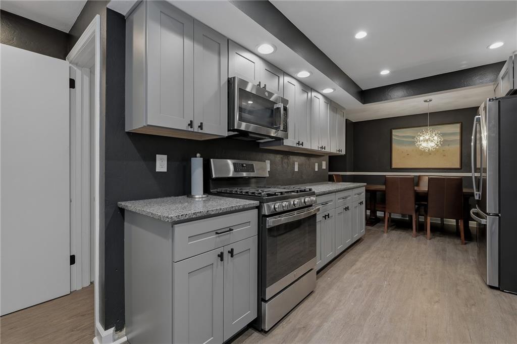 690 Pearce Mill Road Wexford, PA 15090 - Photo 12 of 38 a kitchen with stainless steel appliances granite countertop a stove a sink and a microwave