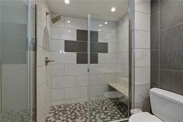 a bathroom with a toilet and a shower