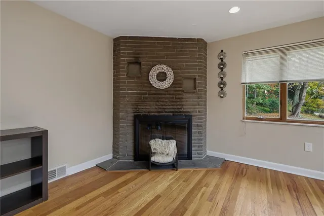 a living room with a fireplace and a floor